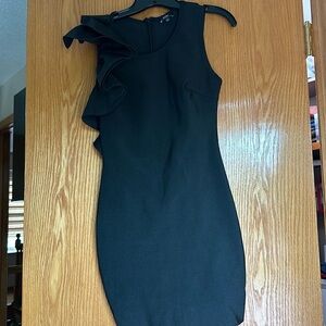 Gorgeous bodycon bandage cocktail dress with ruffle detail on shoulder.